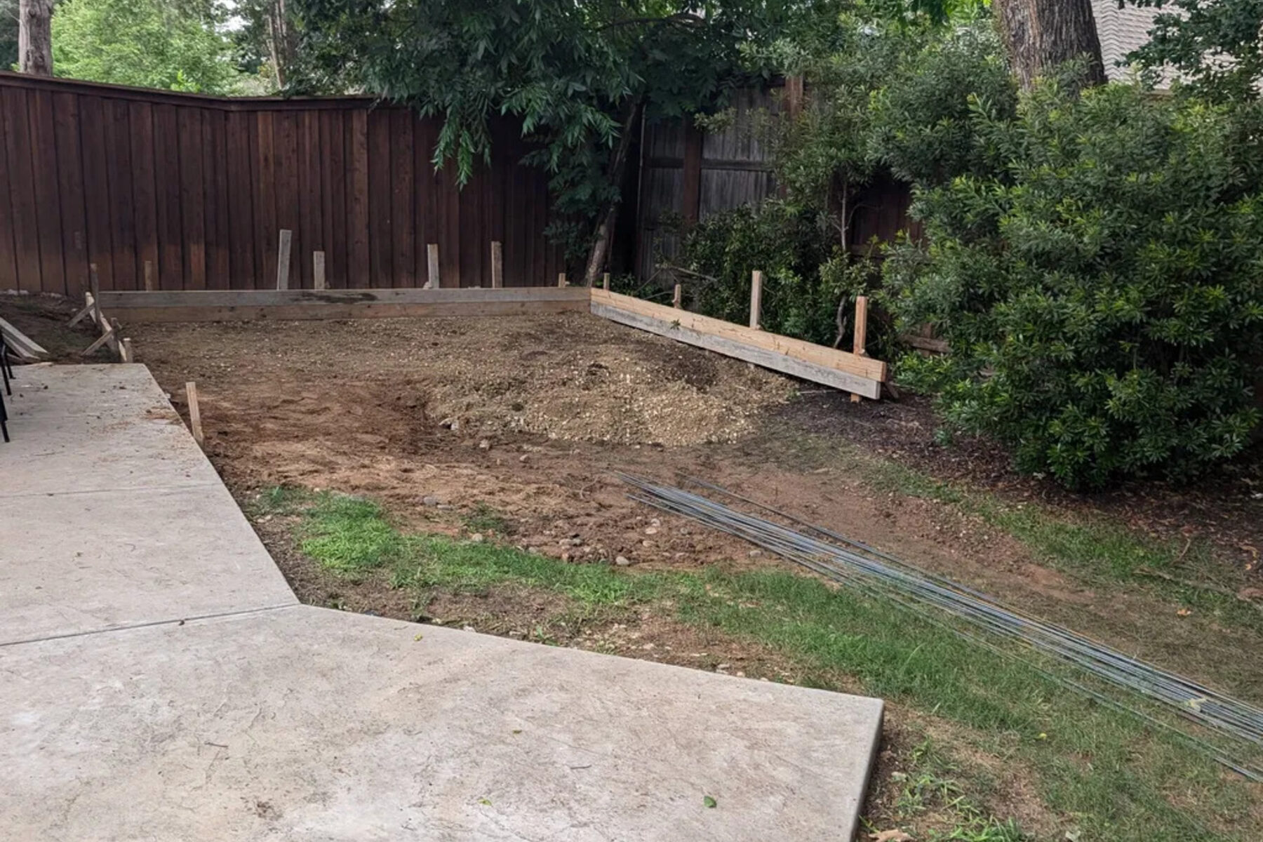 Concrete walkway running along the side of a house